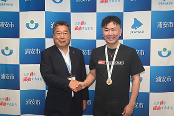 写真：木名瀬大介さんと市長の記念撮影