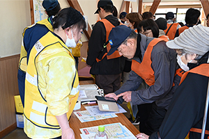 写真：スマートフォンで地図情報を読み取る参加者