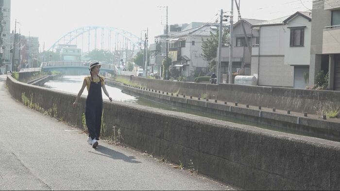 写真：境川の川辺を歩くリポーター