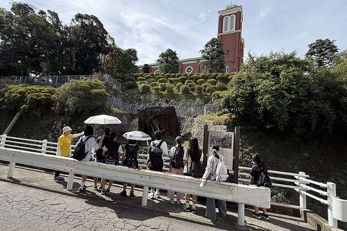 旧浦上天主堂の被爆遺構を見学している様子